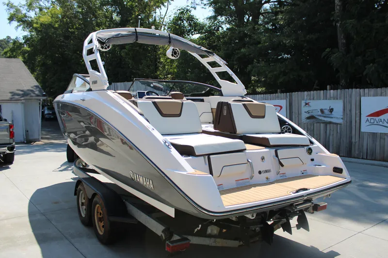 Slide: The Image of 2022 Yamaha Boats 252S on trailer, sleek design, outdoor setting. - 2