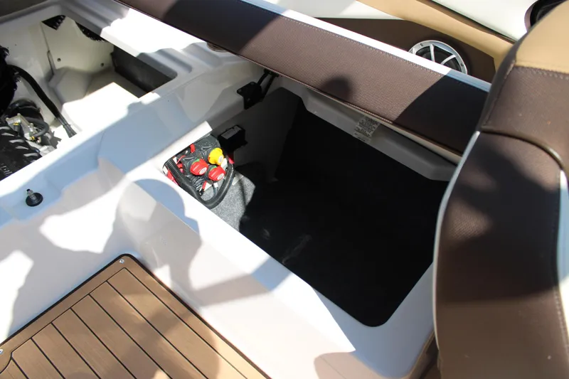 Slide: The Image of 2022 Yamaha Boats 252S interior storage compartment with seating and control panel. - 20