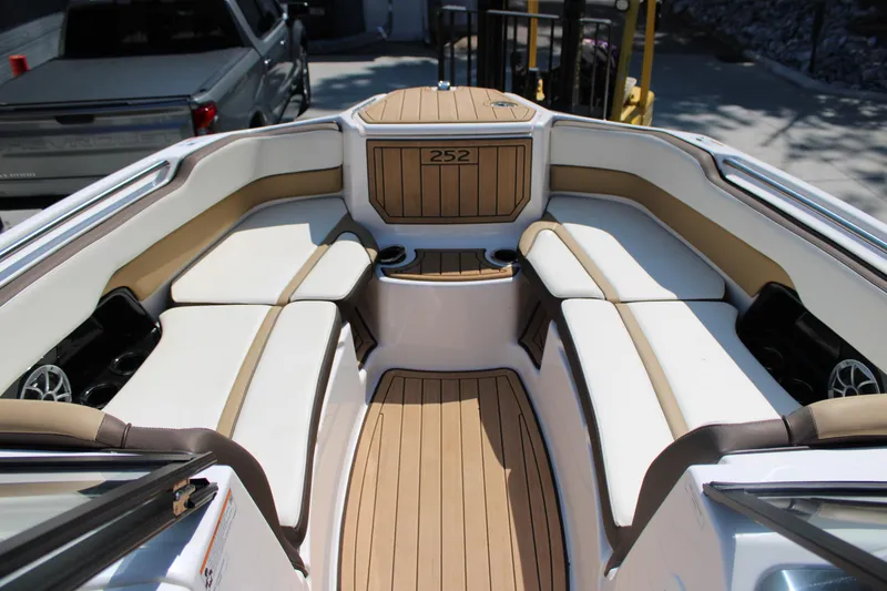 Slide: The Image of 2022 Yamaha Boats 252S interior with luxurious seating and teak-style flooring. - 5