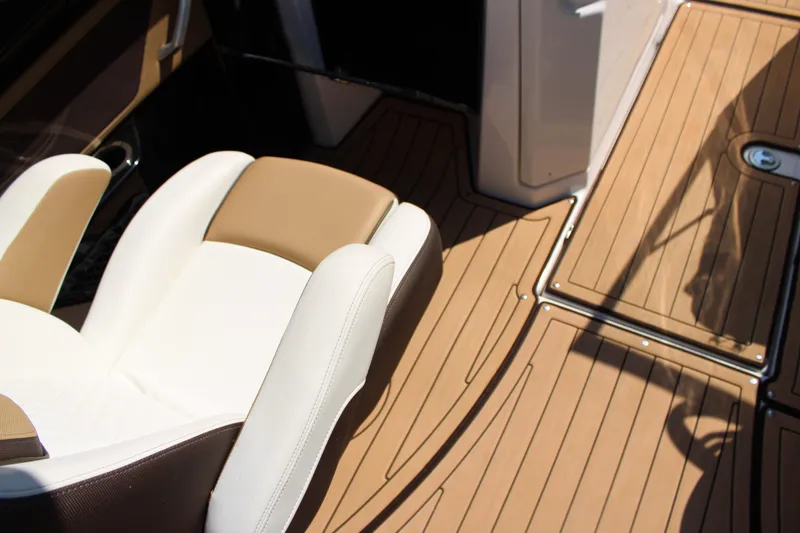 Slide: The Image of 2022 Yamaha Boats 252S interior with tan and white seating, teak-style flooring. - 9