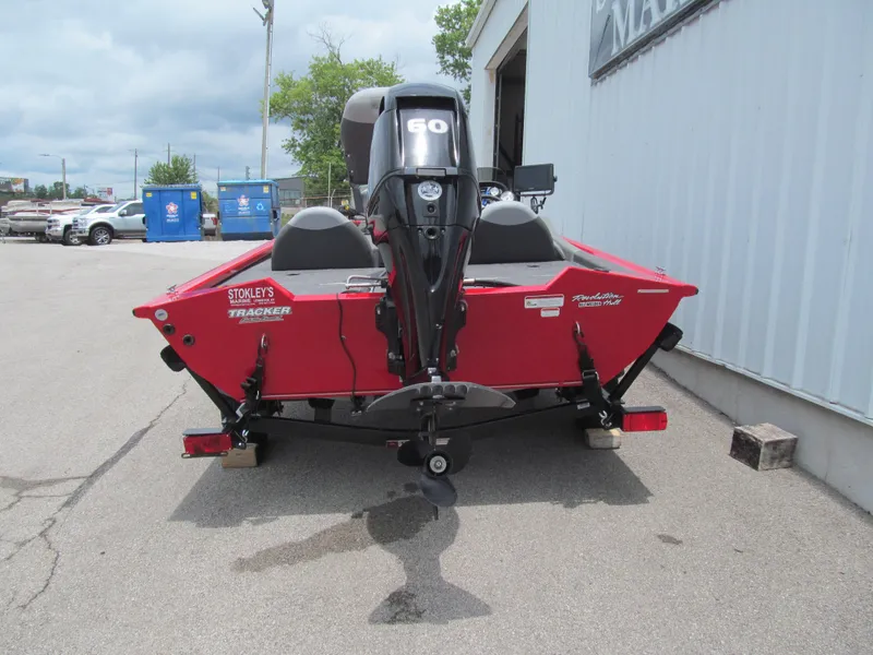 Slide: The Image of 2014 Tracker Pro Team 175 TXW boat, red, parked outside a building. - 4