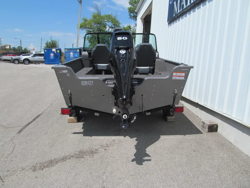 Slide: The Image of 2017 Lowe FM 165 Pro WT boat with 60 HP motor, parked outside a building. - 4
