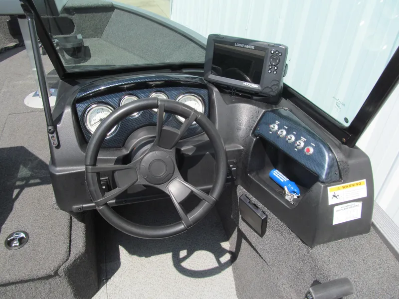 Slide: The Image of 2017 Lowe FM 165 Pro WT boat dashboard with steering wheel and Lowrance fishfinder. - 6