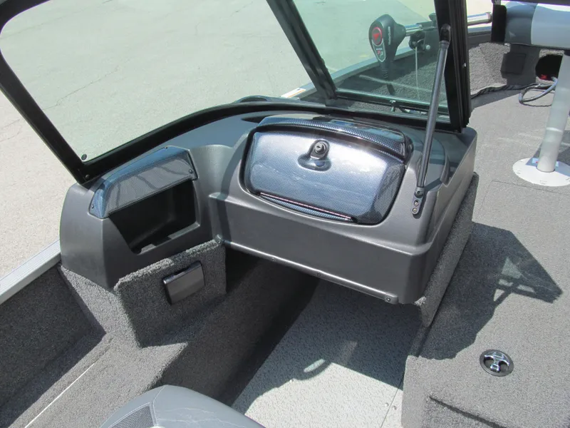 Slide: The Image of 2017 Lowe FM 165 Pro WT boat interior with open storage compartment and windshield. - 7