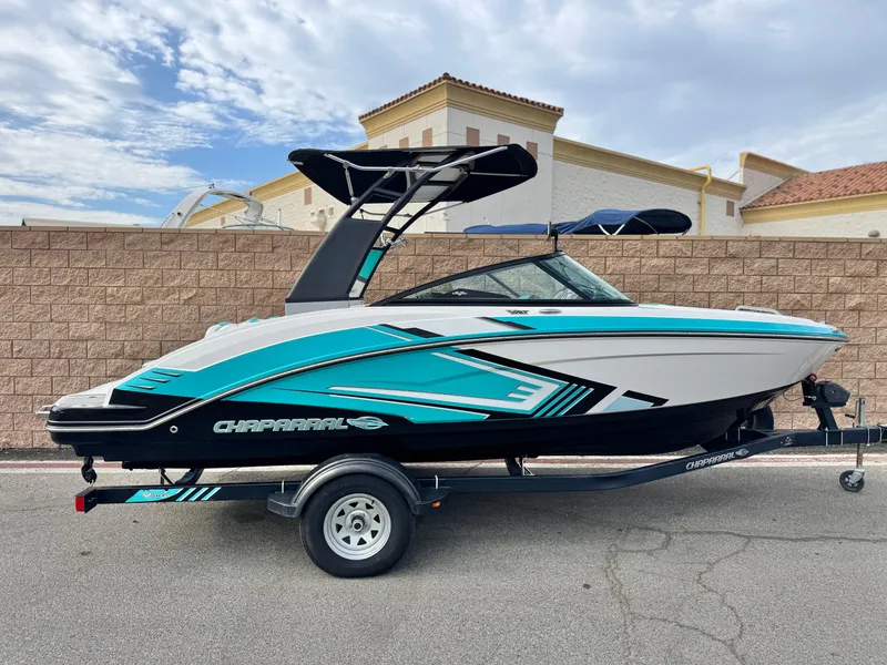 The Image of 2015 Chaparral Vortex 203 VRX boat on trailer, vibrant teal and white design. - 0