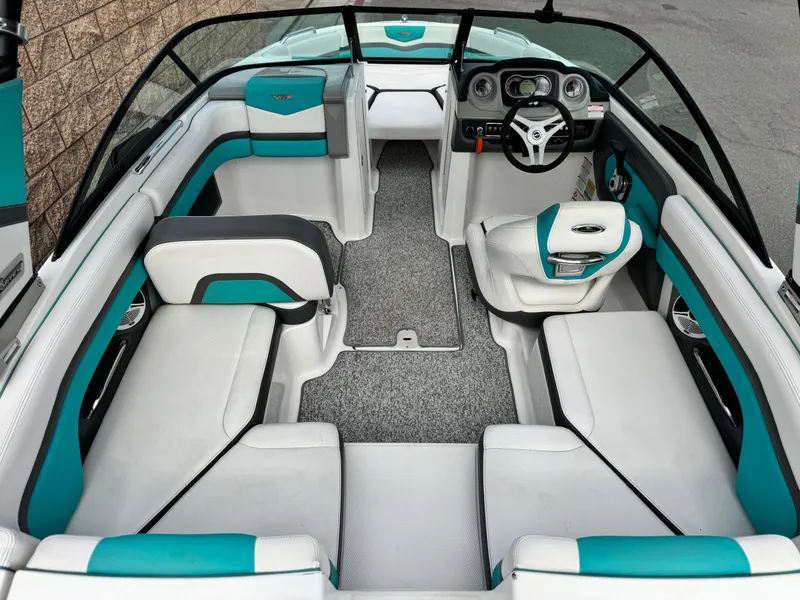 Slide: The Image of 2015 Chaparral Vortex 203 VRX boat interior with teal and white seating, modern dashboard. - 13