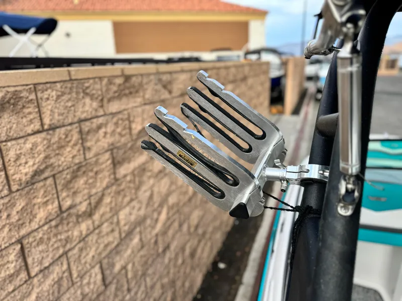 Slide: The Image of Wakeboard rack on a 2015 Chaparral Vortex 203 VRX boat, near a brick wall. - 15