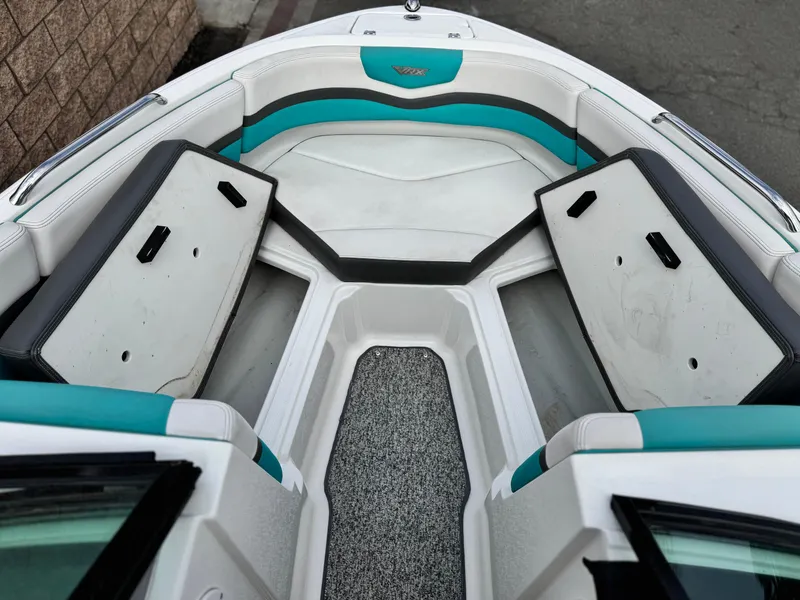 Slide: The Image of 2015 Chaparral Vortex 203 VRX boat interior with teal and white seating. - 18
