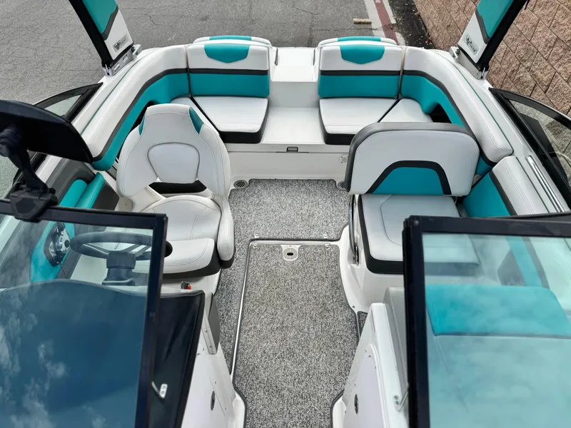 Slide: The Image of 2015 Chaparral Vortex 203 VRX boat interior with teal and white seating. - 19
