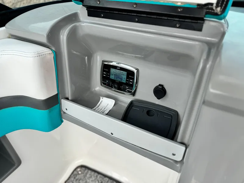 Slide: The Image of 2015 Chaparral Vortex 203 VRX dashboard with stereo system and storage compartment. - 26