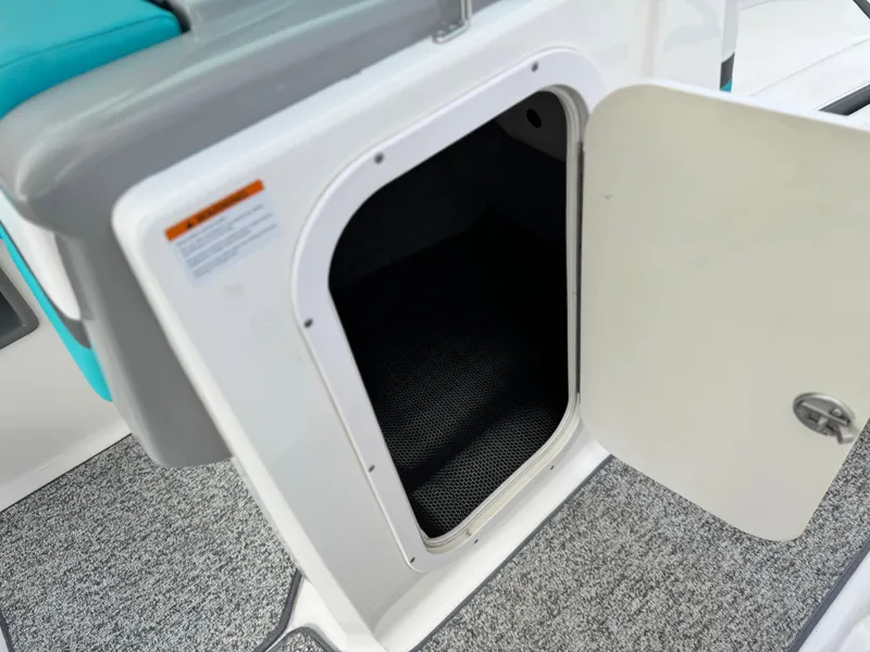 Slide: The Image of Open storage compartment on 2015 Chaparral Vortex 203 VRX boat. - 28
