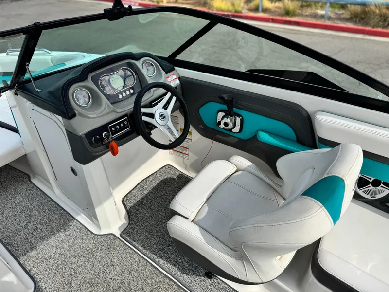 Slide: The Image of 2015 Chaparral Vortex 203 VRX boat interior with steering wheel and seating. - 29