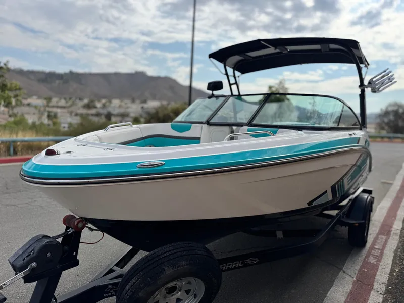 Slide: The Image of 2015 Chaparral Vortex 203 VRX boat on trailer, turquoise and white design, outdoor setting. - 3