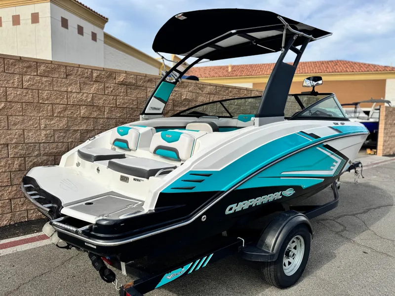 Slide: The Image of 2015 Chaparral Vortex 203 VRX boat with vibrant teal and black design on trailer. - 5