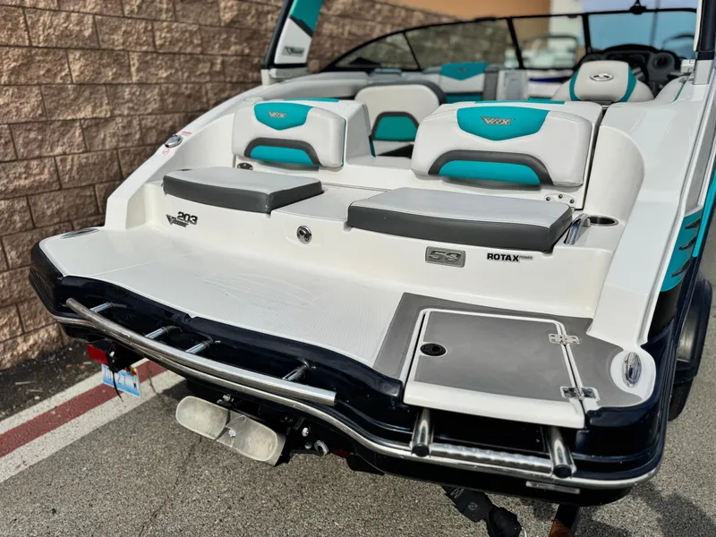 Slide: The Image of 2015 Chaparral Vortex 203 VRX boat with teal and white seating, rear view. - 6