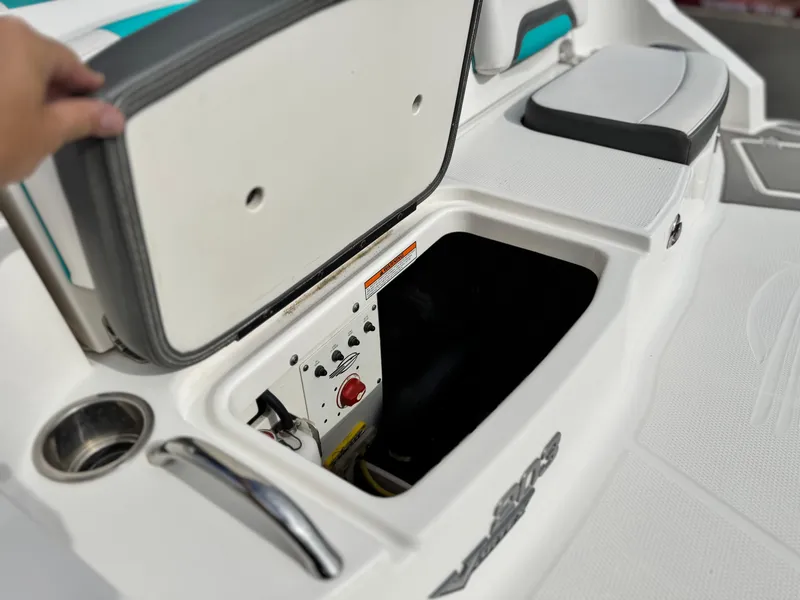 Slide: The Image of 2015 Chaparral Vortex 203 VRX boat storage compartment with open lid and control panel. - 8
