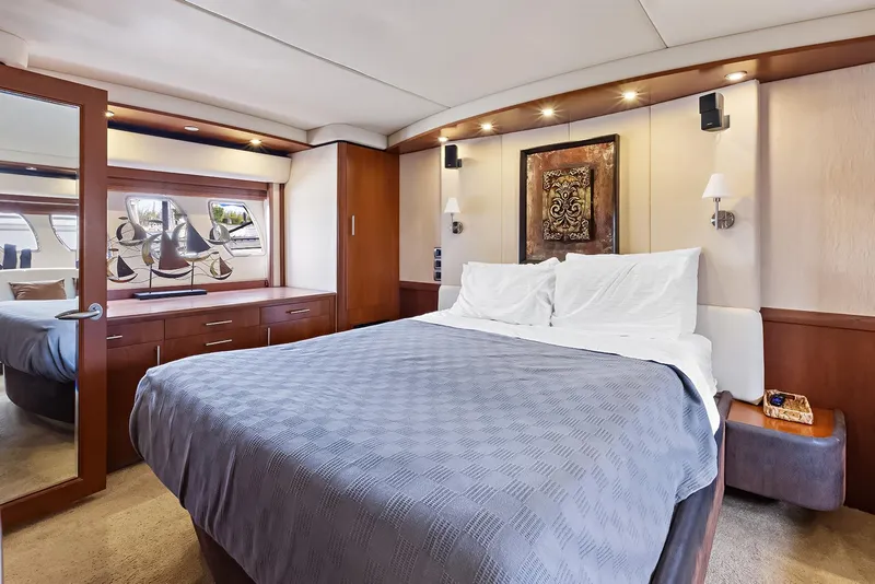 Slide: The Image of Luxurious bedroom interior of 2006 Sea Ray 60 Sundancer yacht with elegant decor and modern amenities. - 11