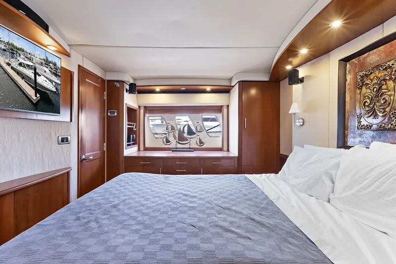 Slide: The Image of Luxurious bedroom interior of 2006 Sea Ray 60 Sundancer yacht with elegant wood finishes. - 12