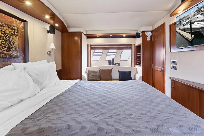 Slide: The Image of Luxurious 2006 Sea Ray 60 Sundancer yacht bedroom with elegant decor and modern amenities. - 13