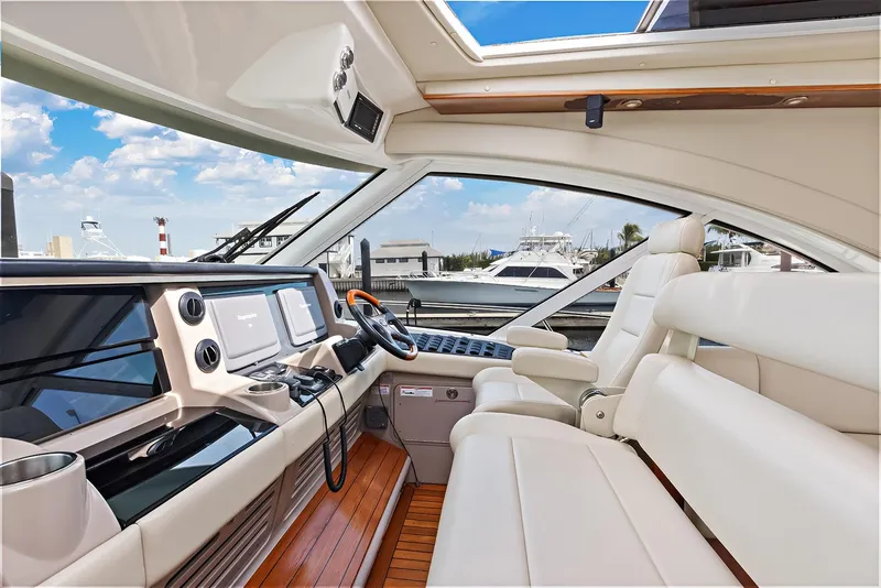 Slide: The Image of 2006 Sea Ray 60 Sundancer helm with luxurious seating and modern navigation equipment. - 17