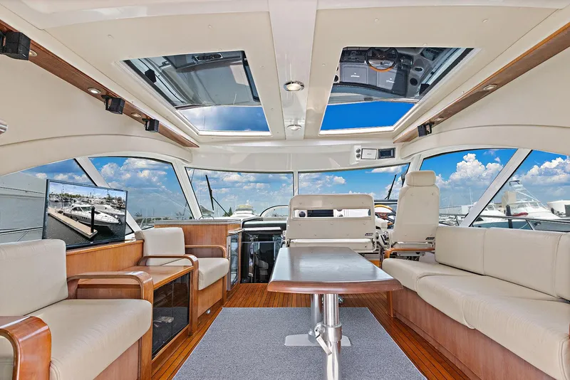 Slide: The Image of Luxurious interior of 2006 Sea Ray 60 Sundancer yacht with panoramic windows and elegant seating. - 21