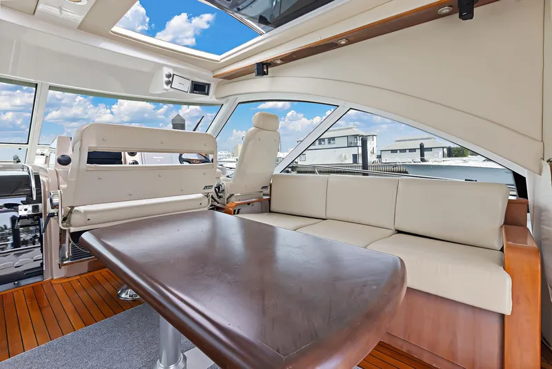 Slide: The Image of Luxurious interior of 2006 Sea Ray 60 Sundancer yacht with plush seating and wooden table. - 22