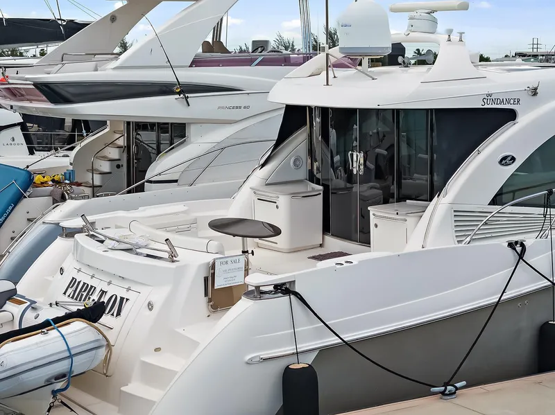 Slide: The Image of 2006 Sea Ray 60 Sundancer yacht docked, featuring spacious deck and modern design. - 37