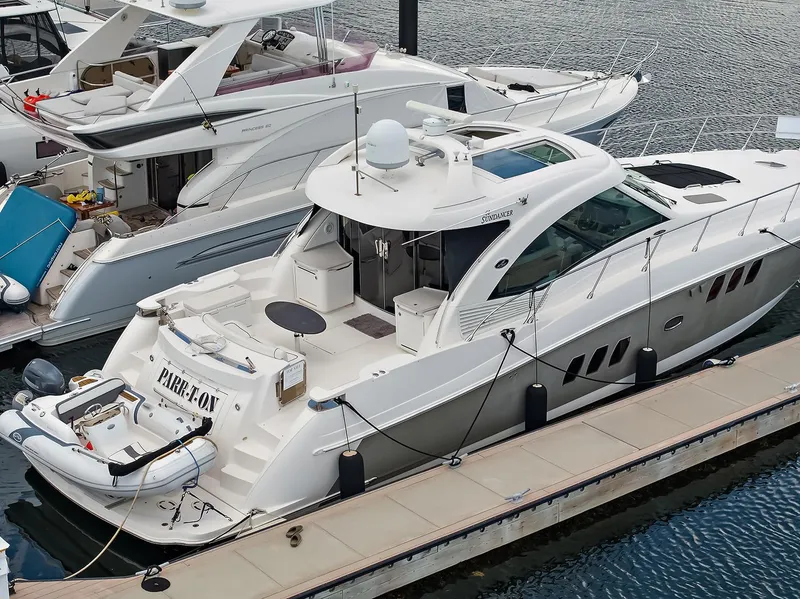 Slide: The Image of 2006 Sea Ray 60 Sundancer yacht docked at marina, featuring sleek design and spacious deck. - 38