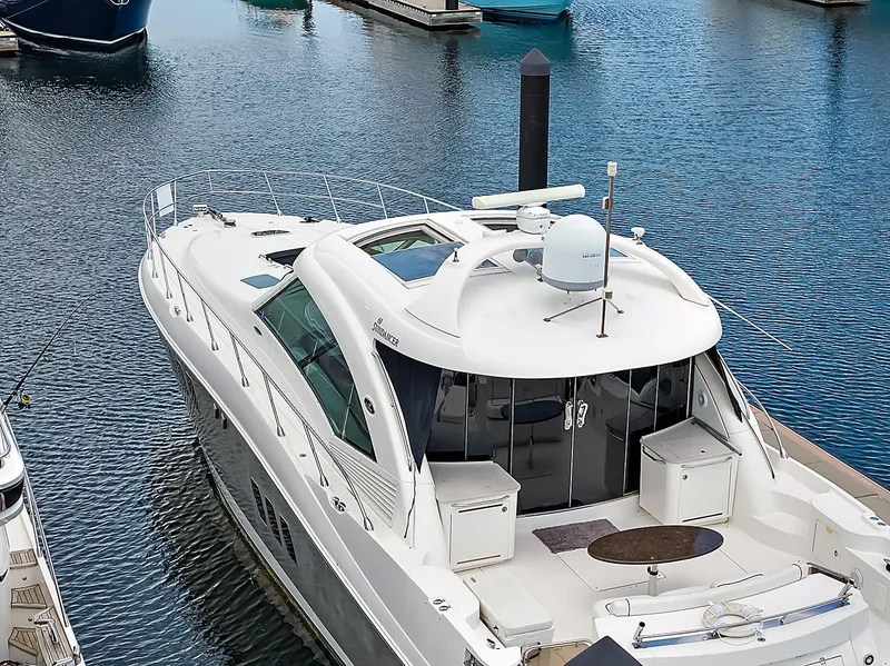 Slide: The Image of 2006 Sea Ray 60 Sundancer yacht docked in a marina, showcasing sleek design and luxury features. - 39