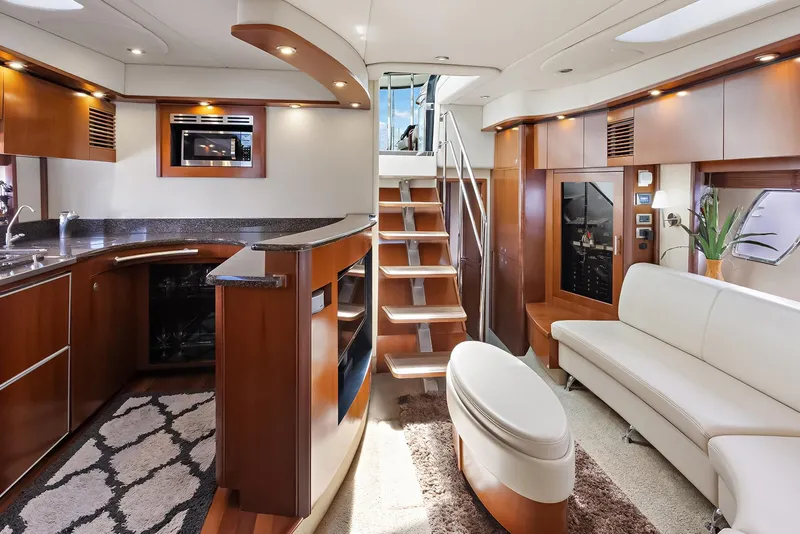 Slide: The Image of Luxurious interior of 2006 Sea Ray 60 Sundancer yacht with modern kitchen and seating area. - 4