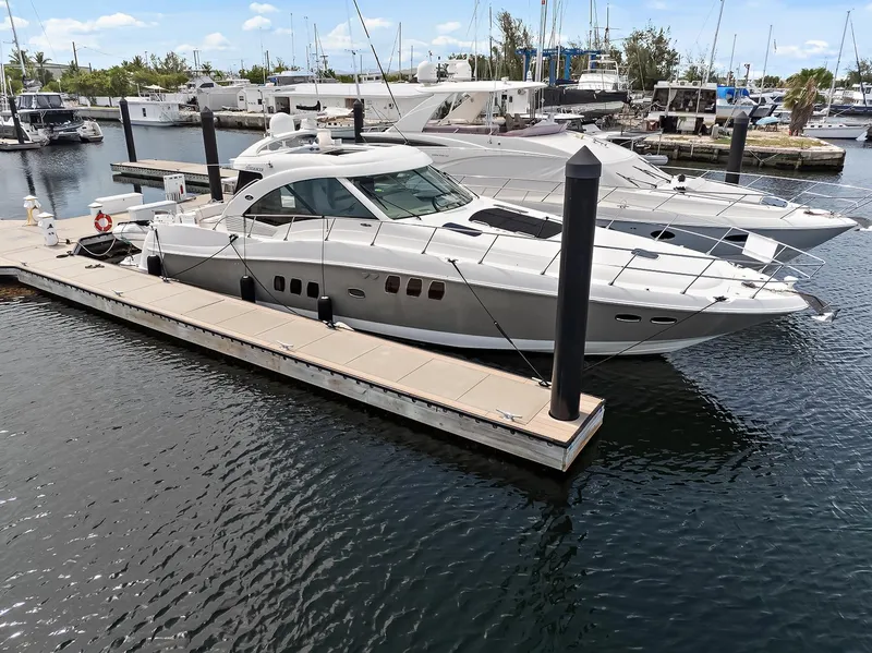 Slide: The Image of 2006 Sea Ray 60 Sundancer yacht docked at marina, calm water, clear sky. - 41