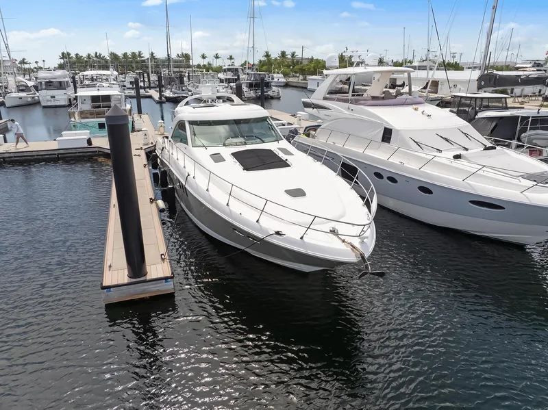 Slide: The Image of 2006 Sea Ray 60 Sundancer yacht docked at marina, surrounded by other boats. - 43