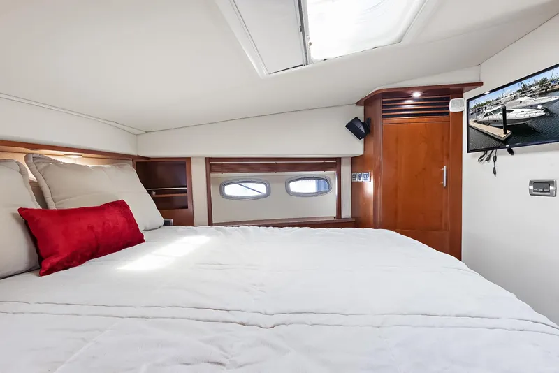 Slide: The Image of Luxurious 2006 Sea Ray 60 Sundancer yacht bedroom with elegant wood accents and modern amenities. - 9