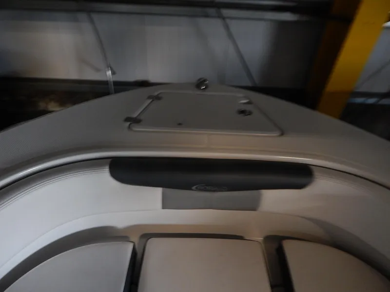 Slide: The Image of 2019 Robalo R202 Explorer boat interior with cushioned seating and storage compartment. - 10