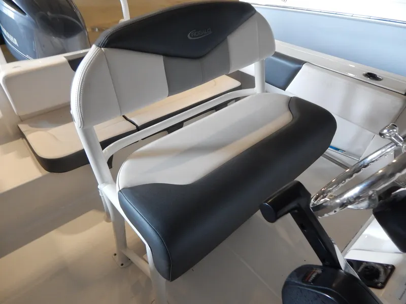 Slide: The Image of 2019 Robalo R202 Explorer boat interior with cushioned seating and steering wheel. - 14