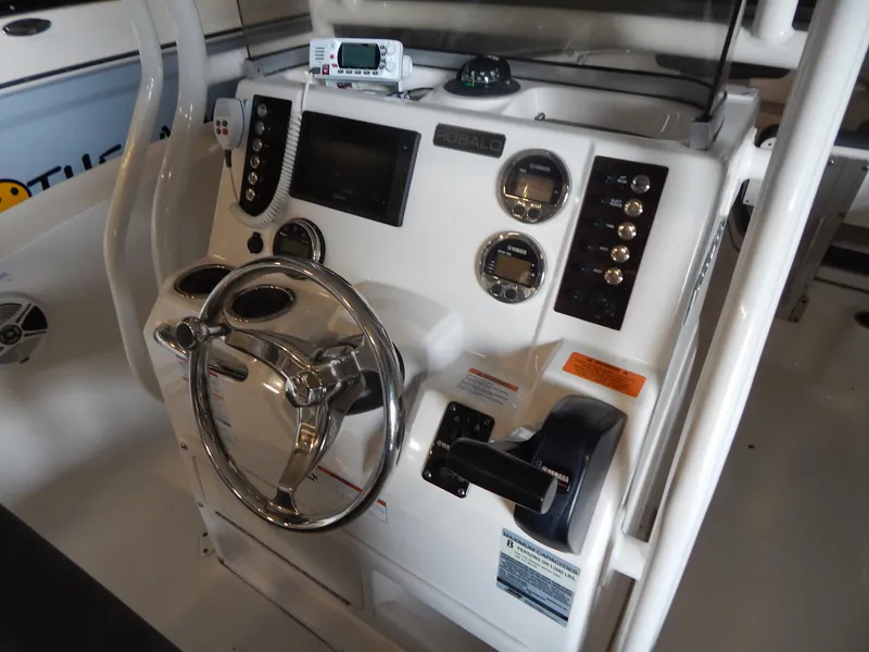 Slide: The Image of 2019 Robalo R202 Explorer boat dashboard with steering wheel and control panel. - 15