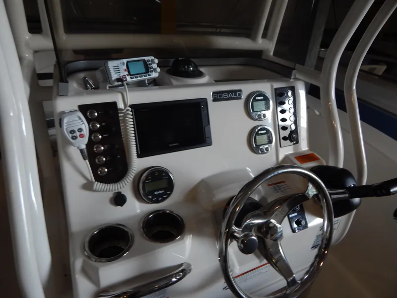 Slide: The Image of 2019 Robalo R202 Explorer boat dashboard with steering wheel and navigation controls. - 16