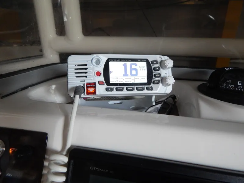 Slide: The Image of VHF radio on 2019 Robalo R202 Explorer boat dashboard, channel 16 displayed. - 19