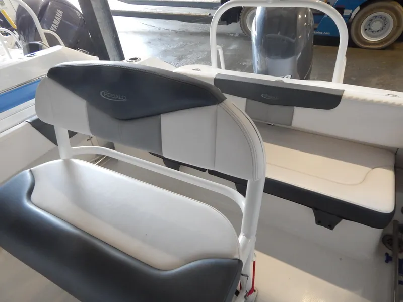 Slide: The Image of 2019 Robalo R202 Explorer boat interior with seating and Yamaha engine. - 21
