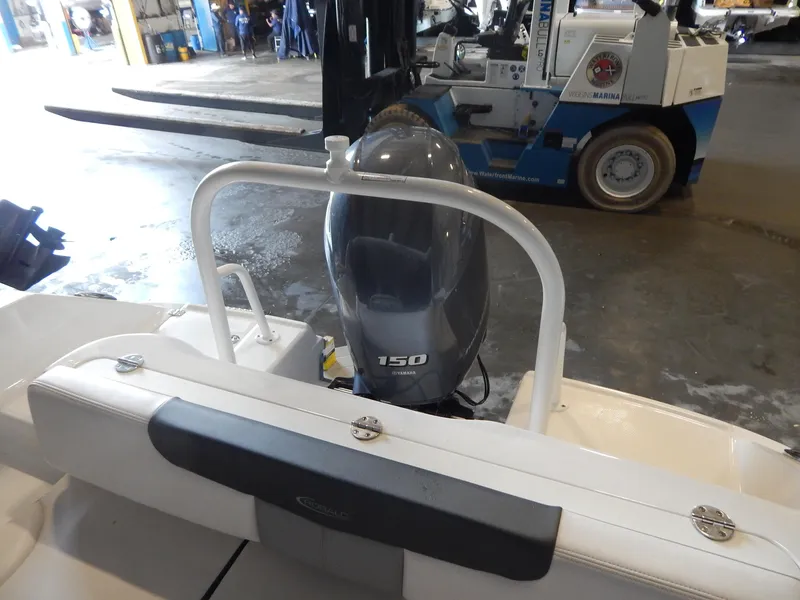 Slide: The Image of 2019 Robalo R202 Explorer boat with Yamaha 150 engine in a workshop setting. - 22