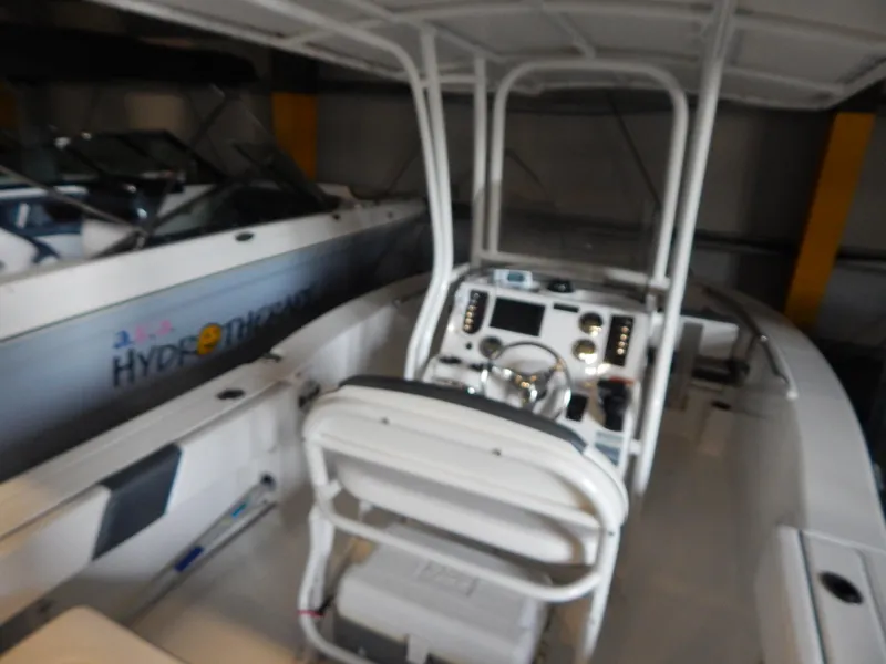 Slide: The Image of 2019 Robalo R202 Explorer boat interior with steering console and seating. - 24