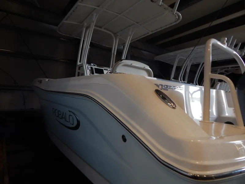Slide: The Image of 2019 Robalo R202 Explorer boat in storage, showcasing sleek design and sturdy structure. - 6