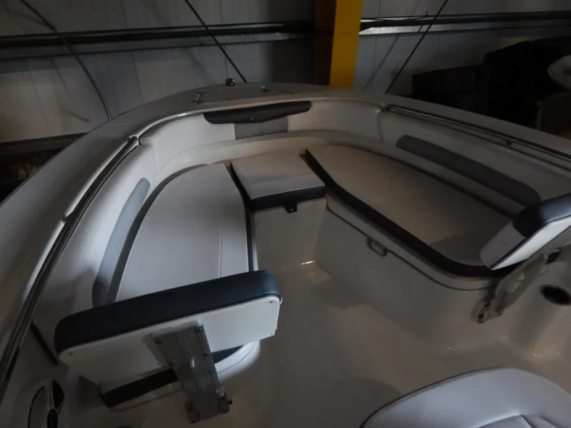 Slide: The Image of 2019 Robalo R202 Explorer boat interior with cushioned seating in a storage area. - 9