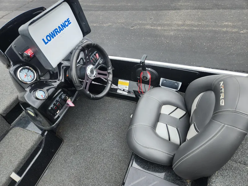 Slide: The Image of Nitro Z17 boat interior with steering wheel, Lowrance display, and cushioned seat, 2017 model. - 5