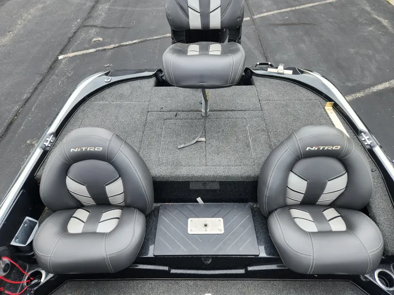 Slide: The Image of 2017 Nitro Z17 boat interior with three gray seats and carpeted flooring. - 7