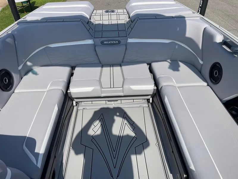 Slide: The Image of 2025 Supra SL boat interior with gray seating and integrated speakers. - 11