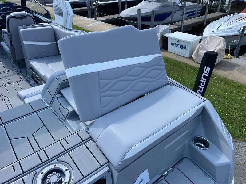 Slide: The Image of 2025 Supra SL boat interior with gray seating and modern design elements. - 12