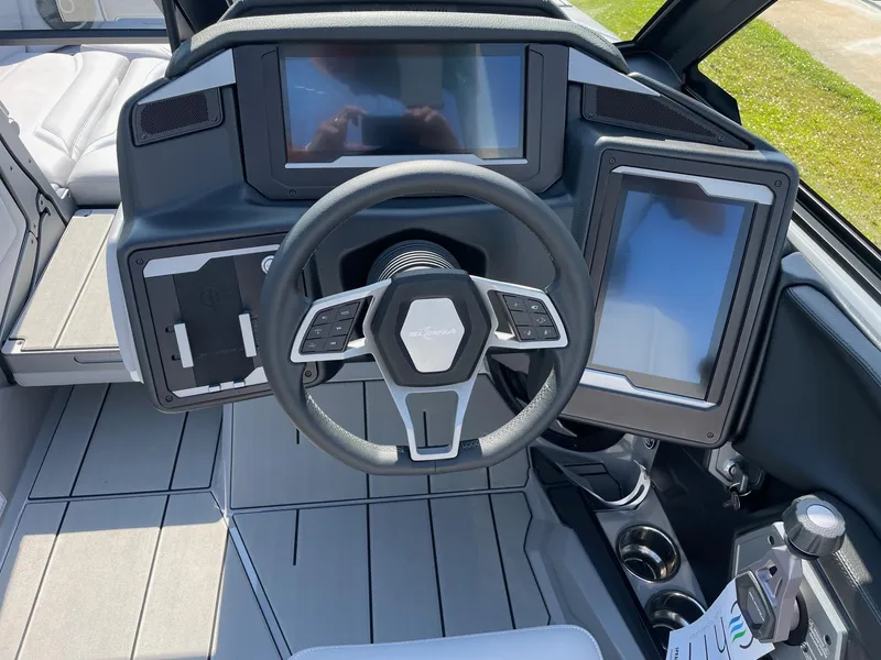 Slide: The Image of 2025 Supra SL boat dashboard with modern steering wheel and digital displays. - 7