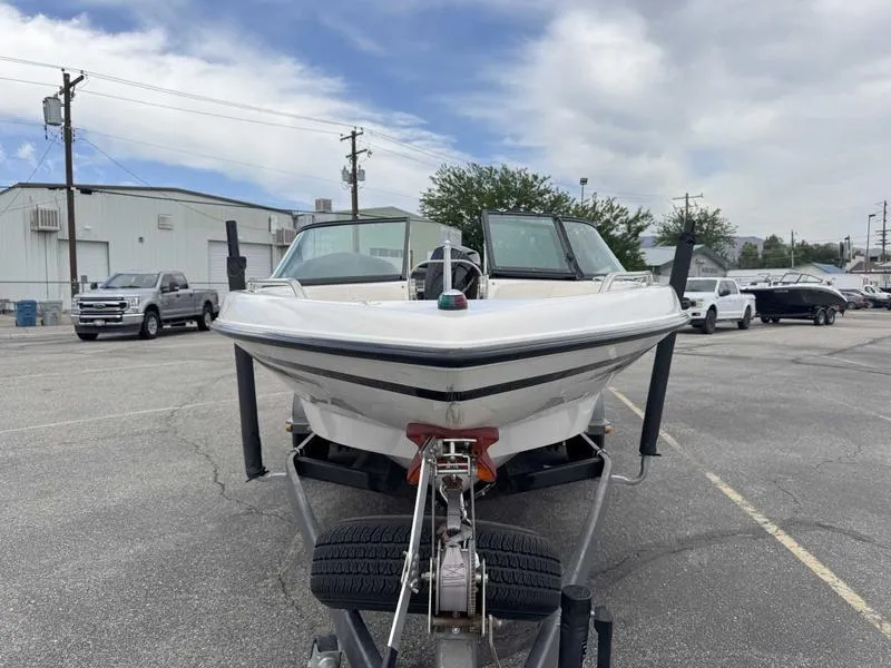Slide: The Image of 1999 MasterCraft Powerstar 200 boat on trailer in parking lot, front view. - 3