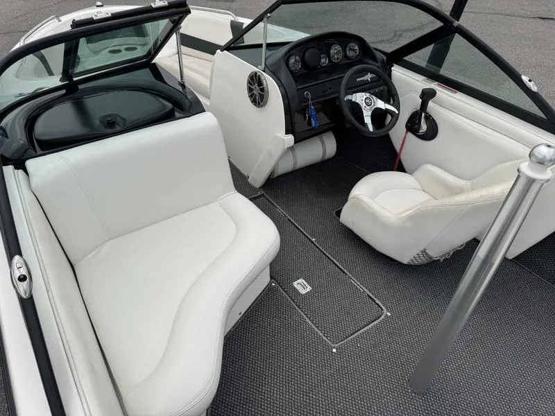 Slide: The Image of 1999 MasterCraft Powerstar 200 boat interior with white seating and modern dashboard. - 5